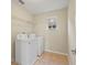 Laundry room with washer, dryer, and shelving at 6370 Golden Dewdrop Trl, Windermere, FL 34786