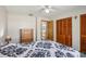 Bedroom with wood closet doors and ensuite bath at 6616 Nw 60Th St, Ocala, FL 34482