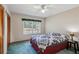 Bedroom with carpeted floor, ceiling fan, and window at 6616 Nw 60Th St, Ocala, FL 34482