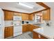 Kitchen with wood cabinets and white appliances at 6616 Nw 60Th St, Ocala, FL 34482