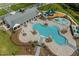 Resort-style pool, playground, and clubhouse with spacious seating areas at 6946 Audobon Osprey Cv, Harmony, FL 34773