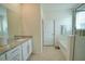 Bathroom with single vanity and garden tub at 6946 Audobon Osprey Cv, Harmony, FL 34773