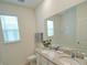 Double vanity bathroom with granite countertop at 6946 Audobon Osprey Cv, Harmony, FL 34773