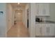 Bright and airy hallway with tile floors and built-in cabinetry at 6946 Audobon Osprey Cv, Harmony, FL 34773