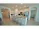 Modern kitchen with island, white cabinets, and granite countertops at 6946 Audobon Osprey Cv, Harmony, FL 34773