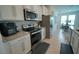 Kitchen boasts stainless steel appliances and granite countertops at 6946 Audobon Osprey Cv, Harmony, FL 34773