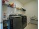 Laundry room with washer, dryer, and shelving at 6946 Audobon Osprey Cv, Harmony, FL 34773