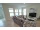 Comfortable living room with sectional sofa and large TV at 6946 Audobon Osprey Cv, Harmony, FL 34773