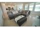 Spacious living room with sectional sofa and large windows at 6946 Audobon Osprey Cv, Harmony, FL 34773