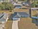 Aerial view showing a newly built home with gray exterior and a paved driveway at 7080 Hemlock Crse, Ocala, FL 34472