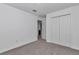 Spacious bedroom with grey carpet, a double door closet and access to bathroom at 7080 Hemlock Crse, Ocala, FL 34472