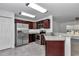 Modern kitchen with stainless steel appliances and dark wood cabinets at 7080 Hemlock Crse, Ocala, FL 34472