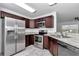 Modern kitchen with stainless steel appliances and dark wood cabinets at 7080 Hemlock Crse, Ocala, FL 34472