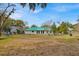 Spacious backyard offering a tranquil setting with mature trees at 750 S Dudley Ave, Bartow, FL 33830