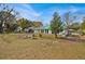 Large backyard with a green roof, and mature trees offering plenty of space for outdoor activities at 750 S Dudley Ave, Bartow, FL 33830