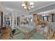 Open dining room with a glass table and view into the kitchen at 750 S Dudley Ave, Bartow, FL 33830