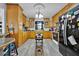 Well-lit kitchen featuring bright wood cabinets, black appliances, and a modern chandelier at 750 S Dudley Ave, Bartow, FL 33830