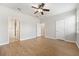 Spacious bedroom with wood-look floors and ceiling fan at 7525 Azalea Cove Cir, Orlando, FL 32807