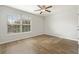 Well-lit bedroom with wood-look floors and ceiling fan at 7525 Azalea Cove Cir, Orlando, FL 32807