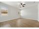 Spacious bedroom with wood-look floors and multiple windows at 7525 Azalea Cove Cir, Orlando, FL 32807