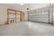 Garage with built-in shelving and painted floor at 7525 Azalea Cove Cir, Orlando, FL 32807