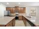 Modern kitchen featuring stainless steel appliances, granite countertops, wood cabinetry, and an island at 7525 Azalea Cove Cir, Orlando, FL 32807