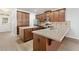Spacious kitchen featuring wood cabinetry, stainless steel appliances, an island, and tile backsplash at 7525 Azalea Cove Cir, Orlando, FL 32807