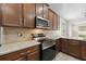 Modern kitchen with stainless steel appliances and wood cabinets at 7525 Azalea Cove Cir, Orlando, FL 32807