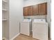 Laundry room with washer, dryer, and cabinets at 7525 Azalea Cove Cir, Orlando, FL 32807