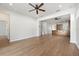 Open living room with wood-look floors and views into kitchen at 7525 Azalea Cove Cir, Orlando, FL 32807