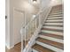 Staircase with white railing and wood steps at 7525 Azalea Cove Cir, Orlando, FL 32807