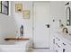 Elegant bathroom with a freestanding tub, sleek white vanity, and black fixtures at 785 N Phelps Ave, Winter Park, FL 32789