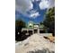 New construction exterior featuring modern design and landscaping, set against a partly cloudy sky at 785 N Phelps Ave, Winter Park, FL 32789