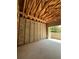New concrete block garage showing exposed ceiling rafters and concrete floor under construction at 785 N Phelps Ave, Winter Park, FL 32789