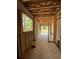 Incomplete garage featuring block walls, exposed wooden ceiling, studs, and concrete floor, awaits finishing touches at 785 N Phelps Ave, Winter Park, FL 32789