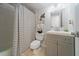 Clean bathroom with a gray vanity, striped shower curtain and white toilet at 805 Weldona Ln # 104, Orlando, FL 32801