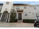 Inviting exterior of a two-story stucco home with a dark brown door and well-manicured landscaping at 805 Weldona Ln # 104, Orlando, FL 32801