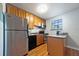 Modern kitchen featuring stainless steel appliances and wood cabinets at 805 Weldona Ln # 104, Orlando, FL 32801