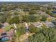 Aerial view of the neighborhood homes surrounded by trees, near a pond and green spaces at 8620 Willow Kane Ct, Orlando, FL 32835