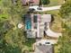 A captivating aerial view of a home with a screened pool, landscaped yard, and beautiful neighborhood at 8620 Willow Kane Ct, Orlando, FL 32835