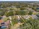 Aerial view of the property, highlighting its position within a serene, tree-filled community near a lake at 8620 Willow Kane Ct, Orlando, FL 32835