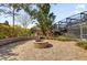 A stone fire pit surrounded by landscaping in a private backyard at 8620 Willow Kane Ct, Orlando, FL 32835