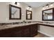 A bathroom with double sinks and a framed mirror at 8620 Willow Kane Ct, Orlando, FL 32835