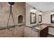 Modern bathroom features double vanity with granite countertop and a glass shower enclosure with tiled walls at 8620 Willow Kane Ct, Orlando, FL 32835