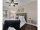 A bedroom with a window, side table, carpeted floors, and natural light at 8620 Willow Kane Ct, Orlando, FL 32835