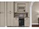 Coffee bar features custom cabinets, tile backsplash, and granite countertop at 8620 Willow Kane Ct, Orlando, FL 32835