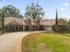 Charming home featuring a brick and stucco facade, lush lawn, and inviting front porch seating at 8620 Willow Kane Ct, Orlando, FL 32835