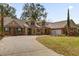 Charming home featuring a brick and stucco facade, lush lawn, and inviting front porch seating at 8620 Willow Kane Ct, Orlando, FL 32835