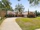 Charming home featuring a brick and stucco facade, lush lawn, and inviting front porch seating at 8620 Willow Kane Ct, Orlando, FL 32835