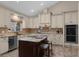 Island with marble counters and breakfast bar stool in this spacious and bright kitchen at 8620 Willow Kane Ct, Orlando, FL 32835